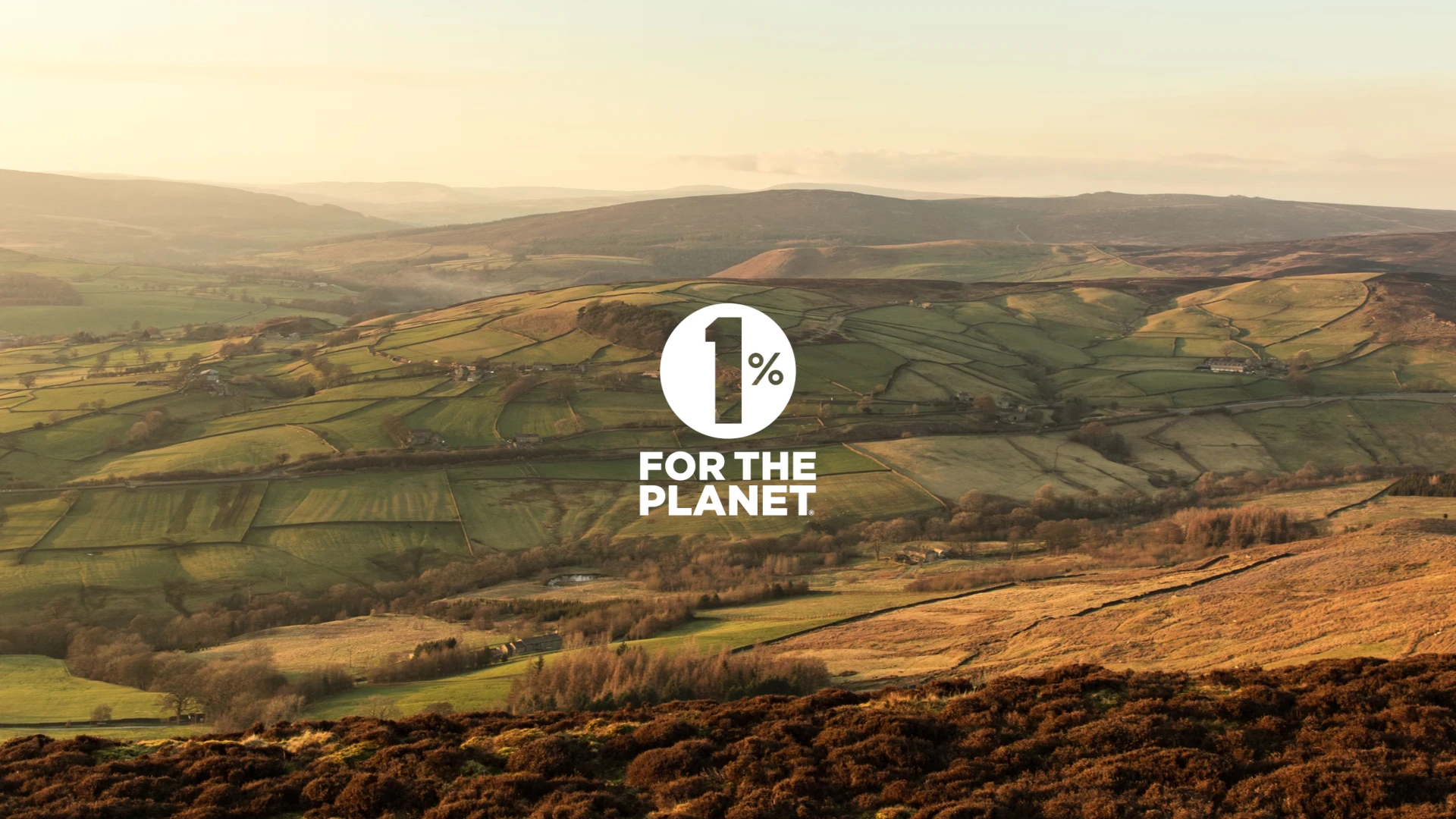 A long-distance photograph of the Yorkshire Dales with the 1% for the Planet logo overlaid