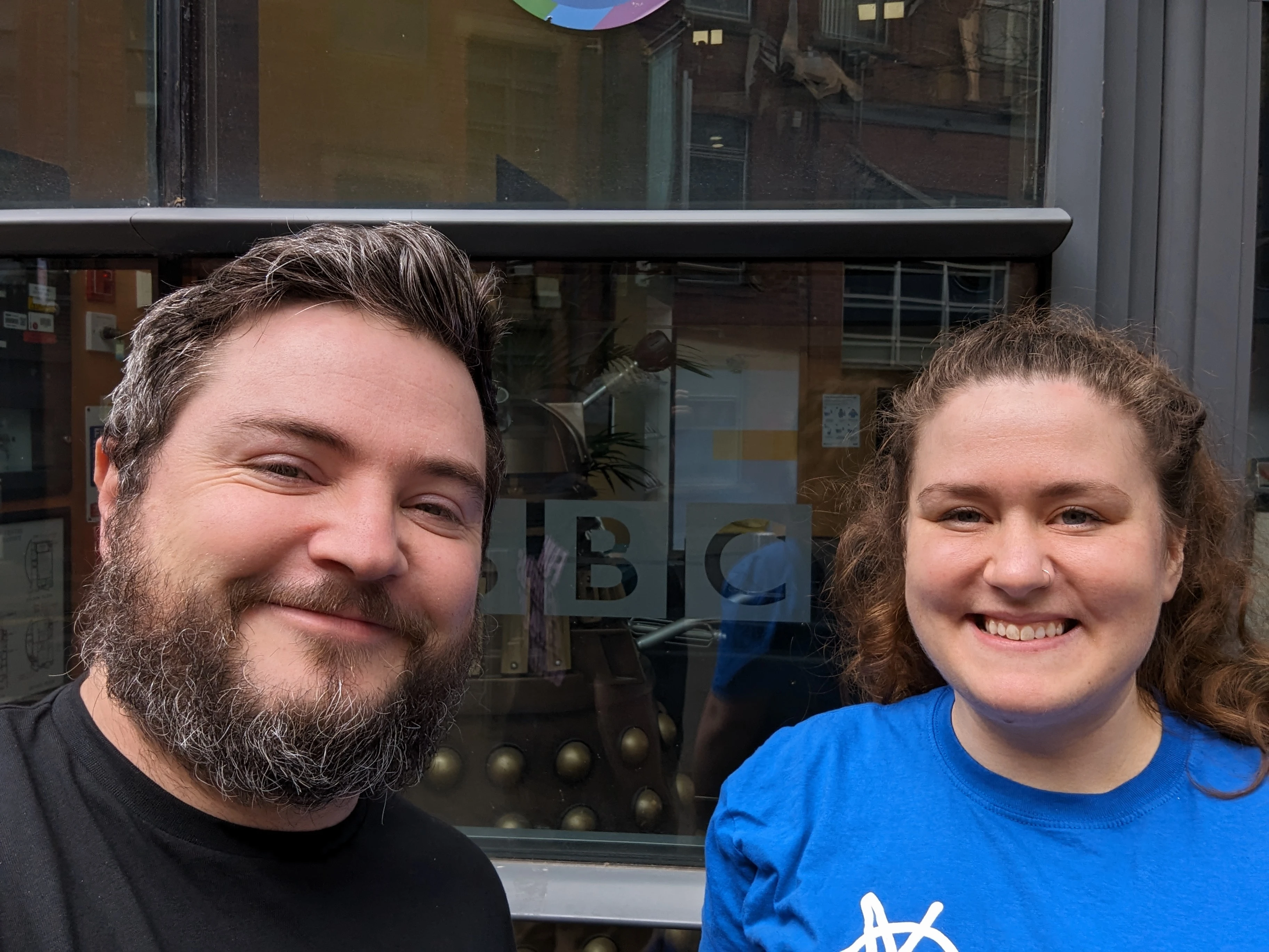 Col and Emily are smiling outside the BBC Radio Leeds Offices