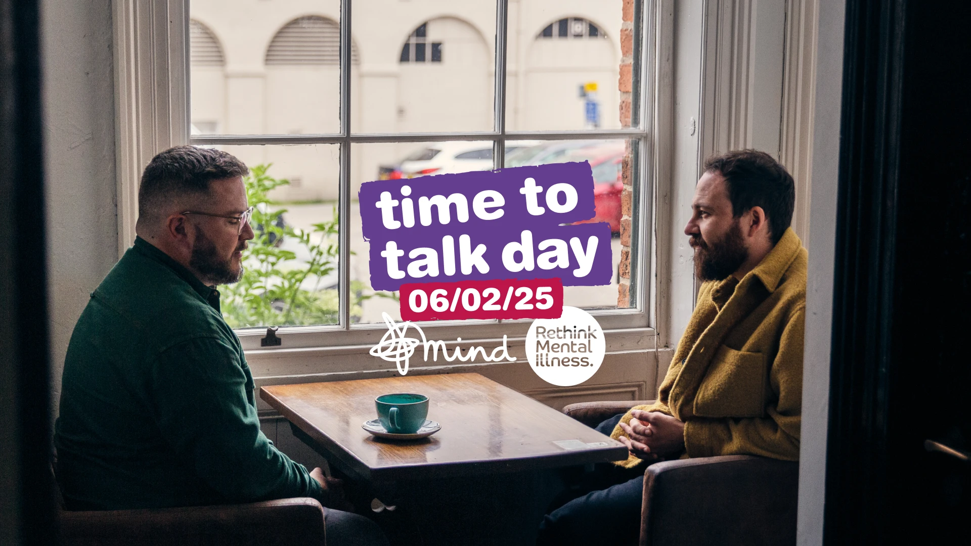 Col and Tom sit and chat over coffee in a local coffee shop, the Time to Talk Day logo is overlaid
